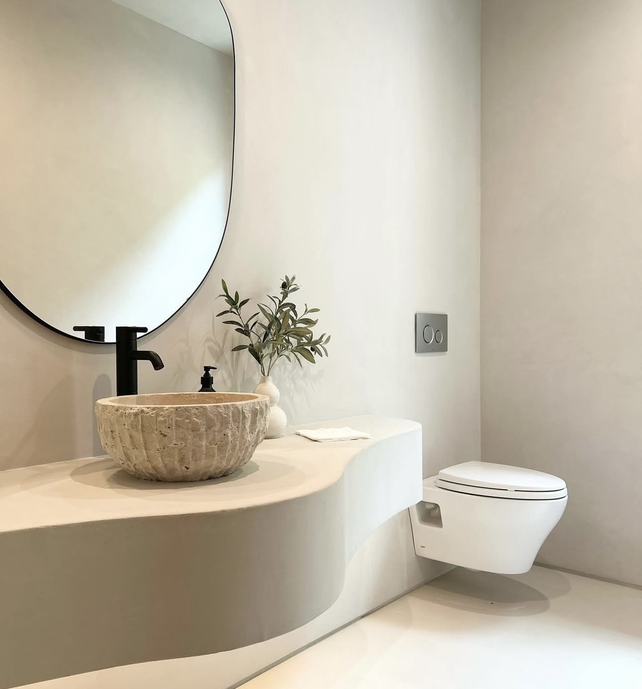 Modern minimalist bathroom with light Concretta plaster finish